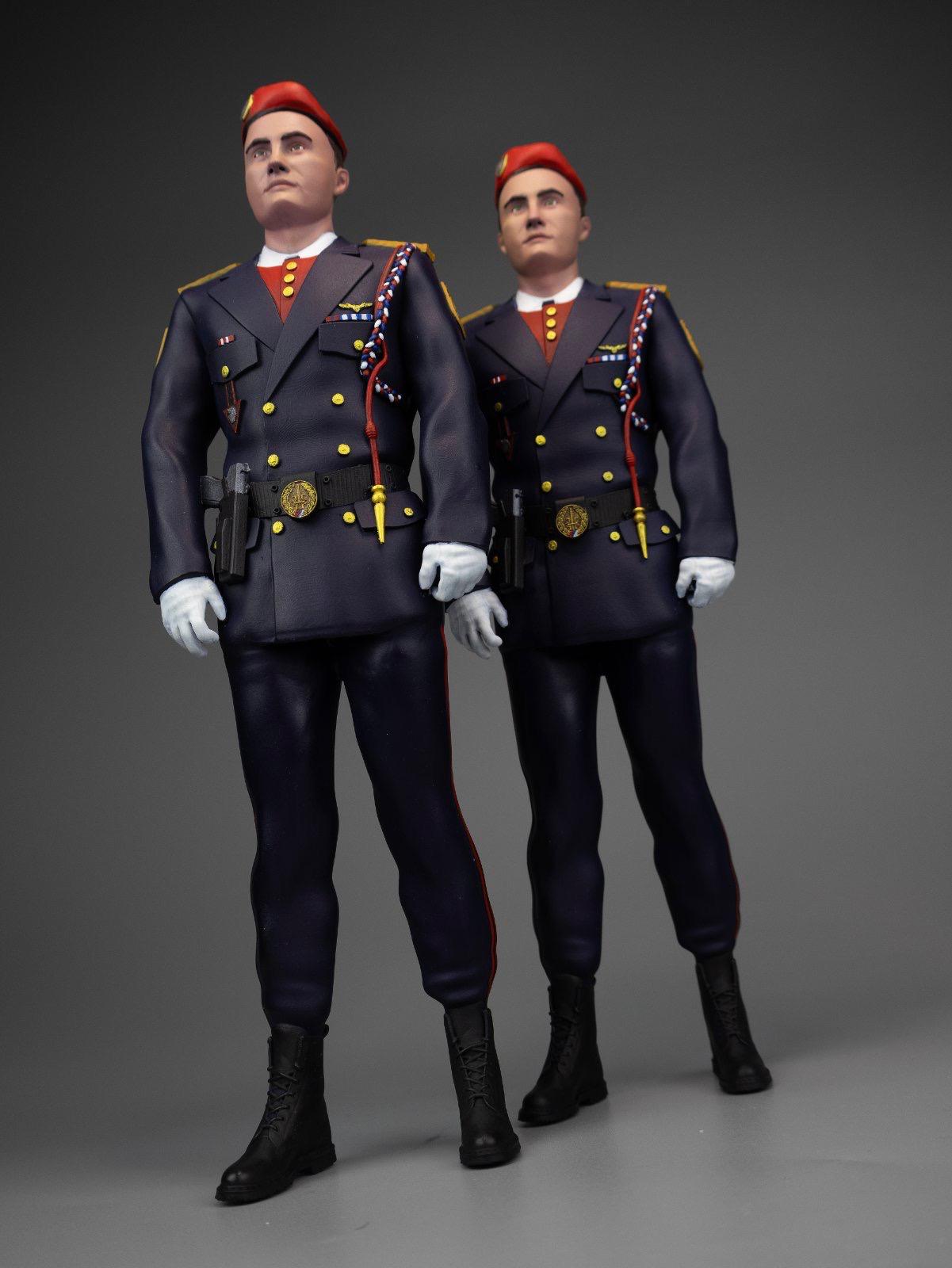 Par 3D štampanih vojnih figura u svečanim uniformama sa crvenim beretkama i opremom.